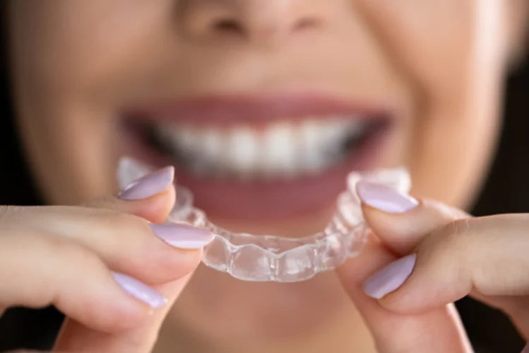 A girl applying clear aligners